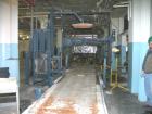 USED: Lantech stretch wrapper, series converted, products model SHASP.               Unit complete with Allen Bradley PLC, 10' powered chain driven live roller conveyor, auto stretch wrapping complet...