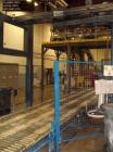 Used Cousins Automatic Stretch Wrapper, Model 7100-65-OHA. The Series 7100 fully automatic conveyorized overhead spiral stretch wrap systems will wrap up to 95 loads per hour, maximum load size 50” w...