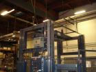 Used Cousins Automatic Stretch Wrapper, Model 7100-65-OHA. The Series 7100 fully automatic conveyorized overhead spiral stretch wrap systems will wrap up to 95 loads per hour, maximum load size 50” w...