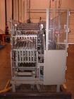 Used Douglas High Speed Bundler, Model MW7-1124 Multi Wrapper. Dual lane, 70 cycle/minute. 480 VAC, 60 hz. Machine has very low operating hours, approximately 200. Machine bundles 4 packs of 2.361
