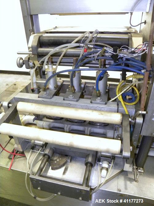 Used Holmatic CBS-18-4F Tamper Evident Inline Heat Sealer. Capable of speeds up to 160 cpm. Three seal head system last running rectangular container. Container range: diameter 1.5 to 5.5" or 38 - 12...