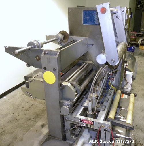 Used Holmatic CBS-18-4F Tamper Evident Inline Heat Sealer. Capable of speeds up to 160 cpm. Three seal head system last running rectangular container. Container range: diameter 1.5 to 5.5" or 38 - 12...