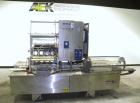 Used Holmatic CBS-18-4F Tamper Evident Inline Heat Sealer. Capable of speeds up to 160 cpm. Three seal head system last running rectangular container. Container range: diameter 1.5 to 5.5