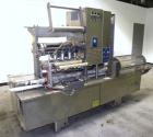 Used Holmatic CBS-18-4F Tamper Evident Inline Heat Sealer. Capable of speeds up to 160 cpm. Three seal head system last running rectangular container. Container range: diameter 1.5 to 5.5