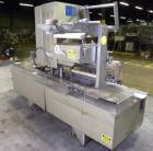 Used Holmatic CBS-18-4F Tamper Evident Inline Heat Sealer. Capable of speeds up to 160 cpm. Three seal head system last running rectangular container. Container range: diameter 1.5 to 5.5