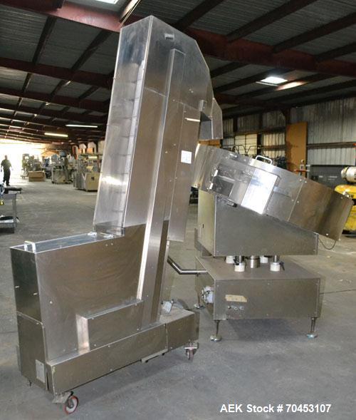 Used Ozaf AC/1500 Bottle Unscrambler, capacity approximately 170-180 units per minute. Includes an OZAF integrated elevator model E/10AG. SELLING PRICE AS IS, WHERE IS, SANFORD, NC.