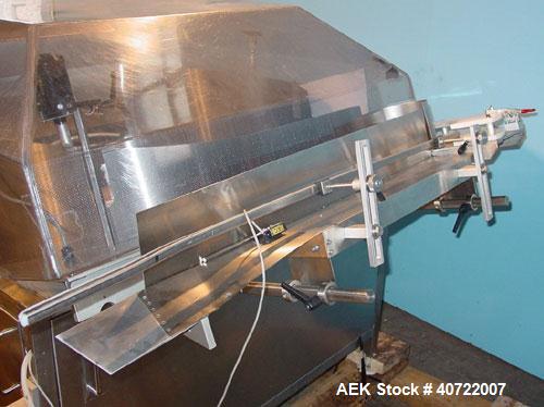 Used Kalish Bottle Unscrambler, model 7400, stainless steel. Feeds containers at up to 100 CPM, 42'' x 32'' x 22'' bulk hopper with 12'' x 28'' flighted rubber elevator belt, 3'' flights spaced 6'' o...
