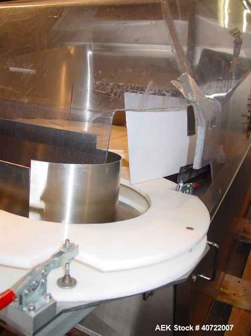 Used Kalish Bottle Unscrambler, model 7400, stainless steel. Feeds containers at up to 100 CPM, 42'' x 32'' x 22'' bulk hopper with 12'' x 28'' flighted rubber elevator belt, 3'' flights spaced 6'' o...