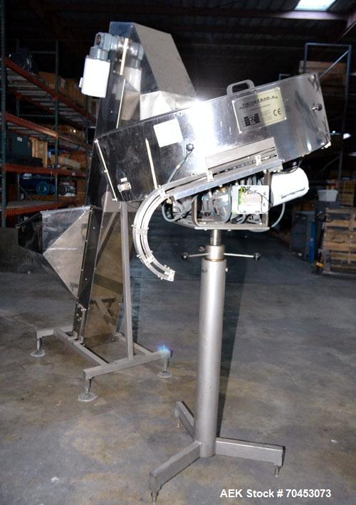 Used Mengibar 44” Diameter Bottle Unscrambler, Model MI-2, Serial #306015, Built 1997. Includes an integrated elevator, model EC300/2000, serial #306015. SELLING PRICE AS IS, WHERE IS, SANFORD, NC.