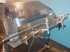 Used Kalish Bottle Unscrambler, model 7400, stainless steel. Feeds containers at up to 100 CPM, 42'' x 32'' x 22'' bulk hopper with 12'' x 28'' flighted rubber elevator belt, 3'' flights spaced 6'' o...
