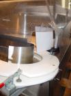 Used Kalish Bottle Unscrambler, model 7400, stainless steel. Feeds containers at up to 100 CPM, 42'' x 32'' x 22'' bulk hopper with 12'' x 28'' flighted rubber elevator belt, 3'' flights spaced 6'' o...