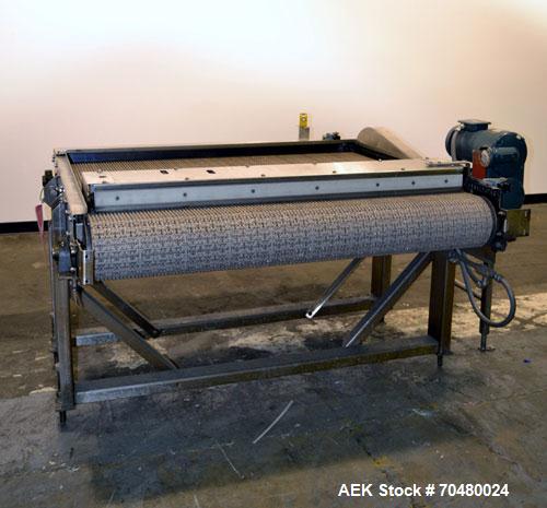 Used Nercon Accumulation Conveyor/Table, Stainless Steel. Approximate 60” wide x 48” long plastic belt with automatic push bar. Driven by a 1/2hp Reeves variable speed gear motor. Stainless steel fra...