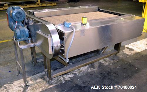 Used Nercon Accumulation Conveyor/Table, Stainless Steel. Approximate 60” wide x 48” long plastic belt with automatic push bar. Driven by a 1/2hp Reeves variable speed gear motor. Stainless steel fra...