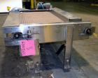 Used Nercon Accumulation Conveyor/Table, Stainless Steel. Approximate 60” wide x 48” long plastic belt with automatic push bar. Driven by a 1/2hp Reeves variable speed gear motor. Stainless steel fra...