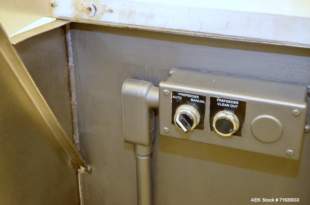 Used Bulk bottle live bottom hopper with integrated stainless steel elevator.