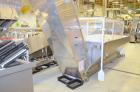 Used Bulk bottle live bottom hopper with integrated stainless steel elevator.