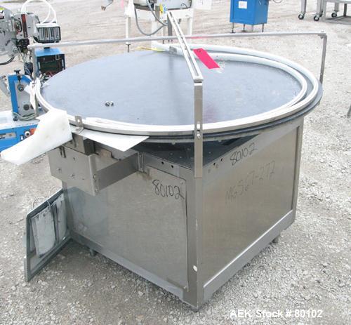 Used Unscrambler Accumulation table, 48" diameter, plastic top. Driven by a 1/4 hp motor with reducer. Mounted on a stainless steel table. Includes an AC inverter drive panel.