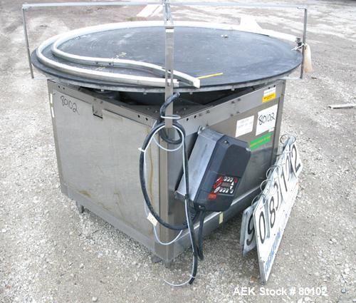 Used Unscrambler Accumulation table, 48" diameter, plastic top. Driven by a 1/4 hp motor with reducer. Mounted on a stainless steel table. Includes an AC inverter drive panel.