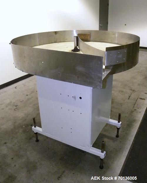 Used Accumulation Table. 48" Diameter plastic table, 5-1/2" tall stainless steel sides, aluminum divider. Driven by a 1/4hp, 1/60/115/208-230 volt, 1725 rpm gear motor. Mounted on a carbon steel base...
