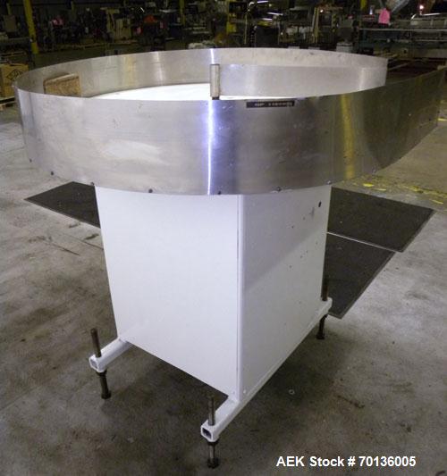 Used Accumulation Table. 48" Diameter plastic table, 5-1/2" tall stainless steel sides, aluminum divider. Driven by a 1/4hp, 1/60/115/208-230 volt, 1725 rpm gear motor. Mounted on a carbon steel base...