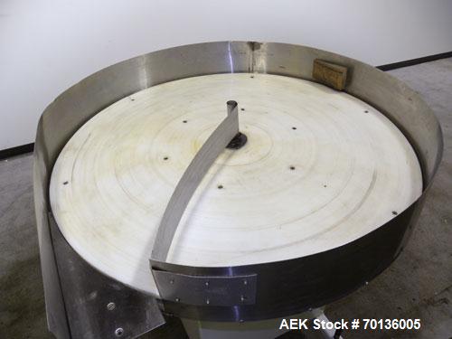 Used Accumulation Table. 48" Diameter plastic table, 5-1/2" tall stainless steel sides, aluminum divider. Driven by a 1/4hp, 1/60/115/208-230 volt, 1725 rpm gear motor. Mounted on a carbon steel base...