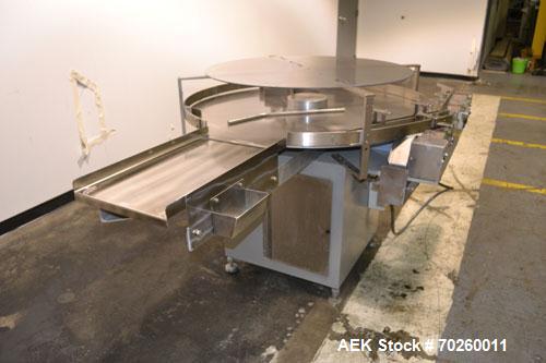 Used Unscramble Accumulating Table, 304 Stainless Steel. 48" Diameter table, 2’’ tall side rails, 14" wide x 24" long in-feed section, 3’’ wide x 36’’ long table top chain conveyor discharge. Driven ...