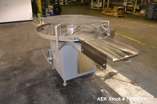 Used Unscramble Accumulating Table, 304 Stainless Steel. 48" Diameter table, 2’’ tall side rails, 14" wide x 24" long in-feed section, 3’’ wide x 36’’ long table top chain conveyor discharge. Driven ...