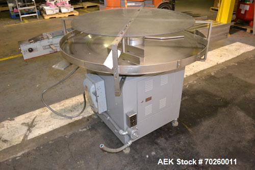 Used Unscramble Accumulating Table, 304 Stainless Steel. 48" Diameter table, 2’’ tall side rails, 14" wide x 24" long in-feed section, 3’’ wide x 36’’ long table top chain conveyor discharge. Driven ...