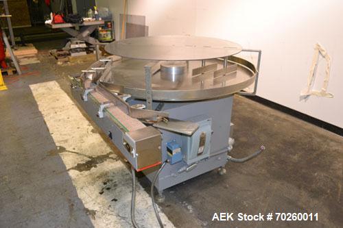 Used Unscramble Accumulating Table, 304 Stainless Steel. 48" Diameter table, 2’’ tall side rails, 14" wide x 24" long in-feed section, 3’’ wide x 36’’ long table top chain conveyor discharge. Driven ...