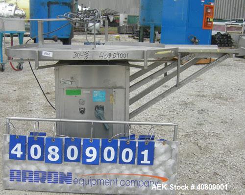 Used Perry Industries Unscrambler, Model VA-48, 304 stainless steel.  48" diameter table, 17 1/2" x 15 1/2" out.  Driven by an approximate 3 hp gearmotor, ratio 300:1.  Mounted on stainless steel leg...