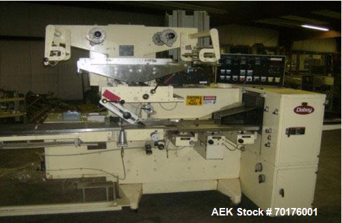 Used Doboy Model J Horizontal Wrapper capable of speeds over 200 packages per minute. Film registration, 1 up sealing head 12" with seal jaws, 10' long lugged chain infeed on 11-1/2" centers. Has pri...