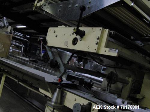 Used Doboy Model J Horizontal Wrapper capable of speeds over 200 packages per minute. Film registration, 1 up sealing head 12" with seal jaws, 10' long lugged chain infeed on 11-1/2" centers. Has pri...