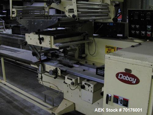 Used Doboy Model J Horizontal Wrapper capable of speeds over 200 packages per minute. Film registration, 1 up sealing head 12" with seal jaws, 10' long lugged chain infeed on 11-1/2" centers. Has pri...