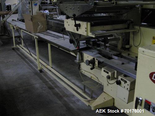 Used Doboy Model J Horizontal Wrapper capable of speeds over 200 packages per minute. Film registration, 1 up sealing head 12" with seal jaws, 10' long lugged chain infeed on 11-1/2" centers. Has pri...