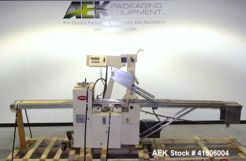 Used Doboy Mustang Horizontal Wrapper. Capable of speeds up to 90 packages per minute. Has a package size range of 1/2" to 7" width x 3" to 15" length, and a maximum height up to 2-3/4". Has an 8" wi...