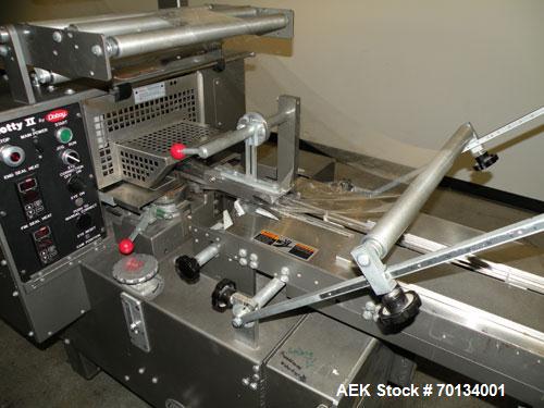Used Doboy Scotty II Horizontal Flow Wrapper. Capable of speeds up to 75 packages per minute. Has 5' Long lugged chain infeed. Package size range: length 4" to 15", width 1" to 5-1/2", height up to 2...