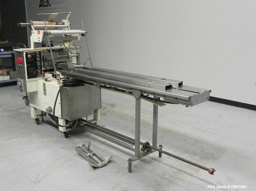 Used Doboy Model Scotty II Horizontal Flow Wrapper. Machine is capable of speeds up to 60 packages per minute. Has 6' Long lugged Carrier Style chain infeed on 12” centers. Package size range: (lengt...