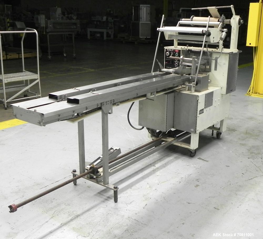 Used Doboy Model Scotty II Horizontal Flow Wrapper. Machine is capable of speeds up to 60 packages per minute. Has 6' Long lugged Carrier Style chain infeed on 12” centers. Package size range: (lengt...