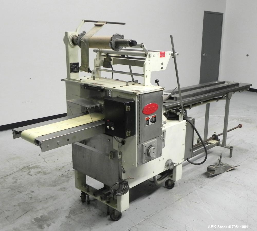 Used Doboy Model Scotty II Horizontal Flow Wrapper. Machine is capable of speeds up to 60 packages per minute. Has 6' Long lugged Carrier Style chain infeed on 12” centers. Package size range: (lengt...