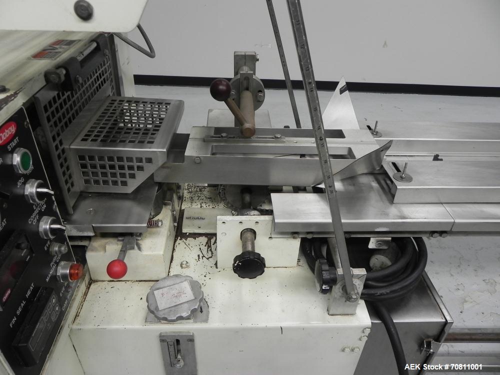 Used Doboy Model Scotty II Horizontal Flow Wrapper. Machine is capable of speeds up to 60 packages per minute. Has 6' Long lugged Carrier Style chain infeed on 12” centers. Package size range: (lengt...