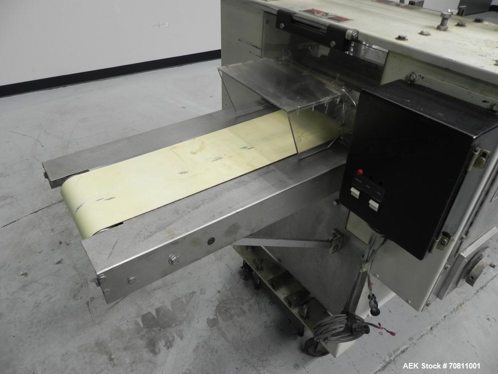Used Doboy Model Scotty II Horizontal Flow Wrapper. Machine is capable of speeds up to 60 packages per minute. Has 6' Long lugged Carrier Style chain infeed on 12” centers. Package size range: (lengt...