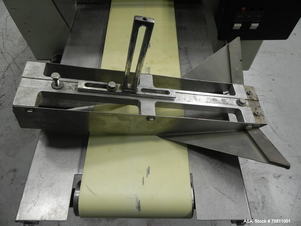 Used Doboy Model Scotty II Horizontal Flow Wrapper. Machine is capable of speeds up to 60 packages per minute. Has 6' Long lugged Carrier Style chain infeed on 12” centers. Package size range: (lengt...