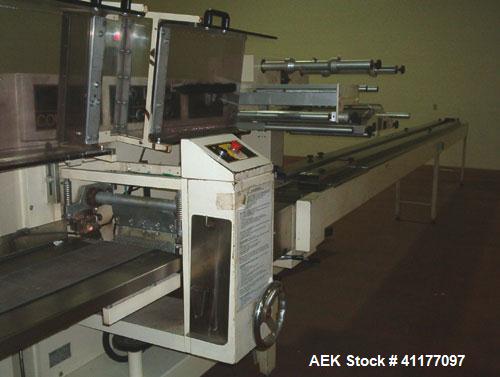 Used Ilapak Cougar Wrapper, Model "UNO". Has a 30' long lugged chain infeed. Stainless steel contact parts. Gussett attachment. Has one 8" wide cross seal jaw mounted on single shaft, two fin seal wh...