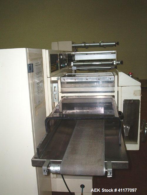 Used Ilapak Cougar Wrapper, Model "UNO". Has a 30' long lugged chain infeed. Stainless steel contact parts. Gussett attachment. Has one 8" wide cross seal jaw mounted on single shaft, two fin seal wh...