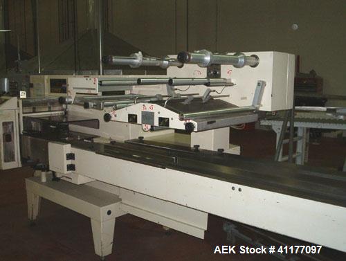 Used Ilapak Cougar Wrapper, Model "UNO". Has a 30' long lugged chain infeed. Stainless steel contact parts. Gussett attachment. Has one 8" wide cross seal jaw mounted on single shaft, two fin seal wh...