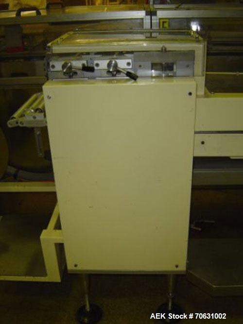 Used Otem M300DX Flowpack Wrapper.  Maximum pack height 3.5" (90 mm).  Maximum pack length 15" (380 mm).  Knives 9.4" (240 mm) long.  Maximum pack width 7.8" (200 mm).  Optional cardboard base feeder...