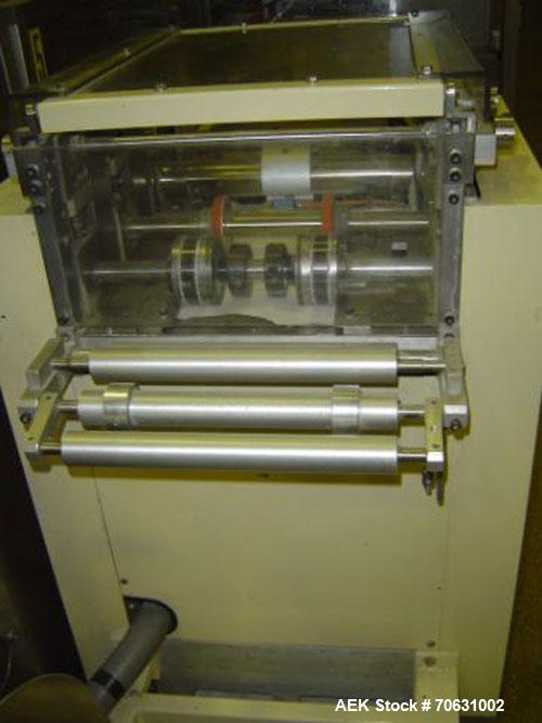 Used Otem M300DX Flowpack Wrapper.  Maximum pack height 3.5" (90 mm).  Maximum pack length 15" (380 mm).  Knives 9.4" (240 mm) long.  Maximum pack width 7.8" (200 mm).  Optional cardboard base feeder...