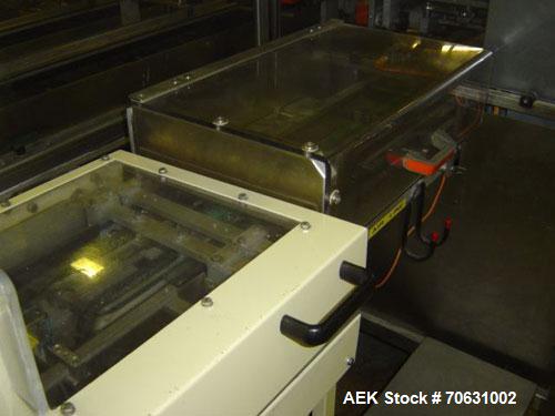 Used Otem M300DX Flowpack Wrapper.  Maximum pack height 3.5" (90 mm).  Maximum pack length 15" (380 mm).  Knives 9.4" (240 mm) long.  Maximum pack width 7.8" (200 mm).  Optional cardboard base feeder...