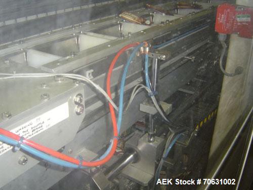 Used Otem M300DX Flowpack Wrapper.  Maximum pack height 3.5" (90 mm).  Maximum pack length 15" (380 mm).  Knives 9.4" (240 mm) long.  Maximum pack width 7.8" (200 mm).  Optional cardboard base feeder...