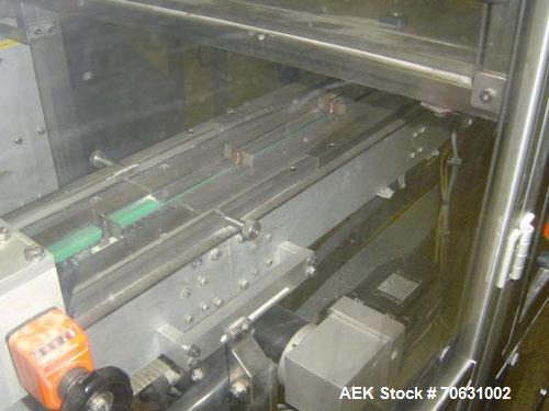 Used Otem M300DX Flowpack Wrapper.  Maximum pack height 3.5" (90 mm).  Maximum pack length 15" (380 mm).  Knives 9.4" (240 mm) long.  Maximum pack width 7.8" (200 mm).  Optional cardboard base feeder...